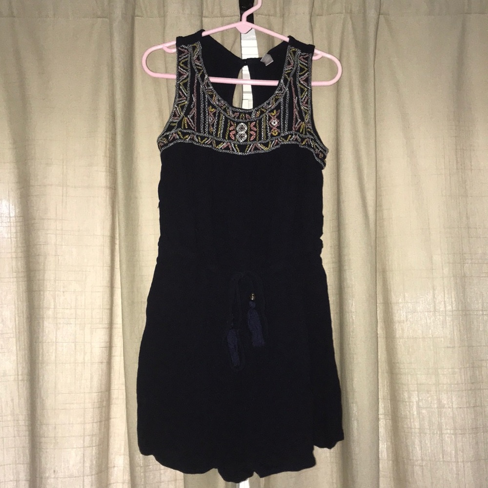 A romper with a very cute embroidered design.